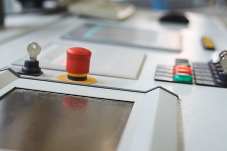 Control panel with buttons and touchscreen in control room of factory. Close-up of working process.