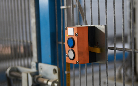 Start or stop button for industrial machine, close-up. Emergency Stop for Safety concept. Red...