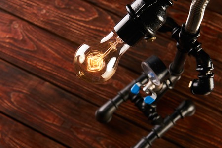 Black desk lamp made of water pipes and gauge pressure meter.