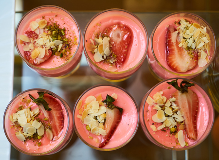 Dessert with fresh strawberry top view, cream cheese and strawberry jam on glass, close-upの写真素材