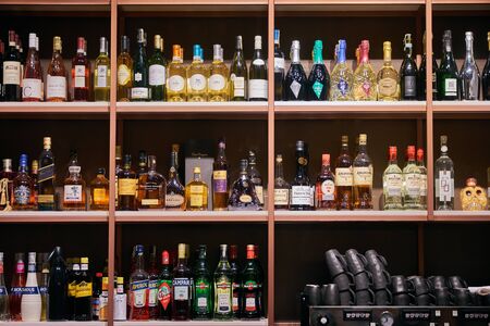 Azerbaijan Baku - April 03, 2018: Bottles of alcohol and spirits at a restaurant bar. Large variety of imported and domestic labels, brands and supplies for making cocktails and drinks. Copy spaceのeditorial素材
