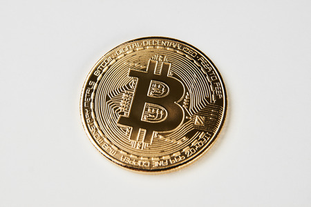 Golden bitcoin isolated on white background. Cryptocurrency coin, close-up
