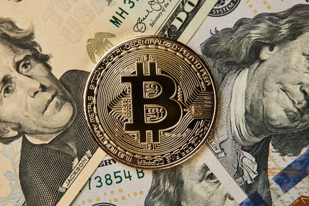 Bitcoin cryptocurrency money and us dollar money, close-up. Exchange concept