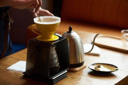 Barista making coffee, bartender or coffee maker preparing coffee drinkの写真素材