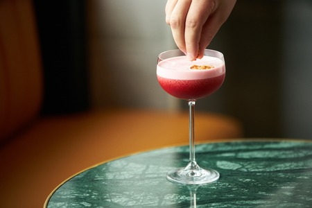 Alcoholic Cocktail glass drink on table in bar restaurant, close-upの写真素材