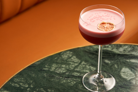 Classical Katana cocktail on table, close-up. Freshly cocktail with Rum, Passionfruit pure, Egg white, Sumax syrup, Ginger infuse. Sour-sweet, light, spicy alcoholic drinkの写真素材