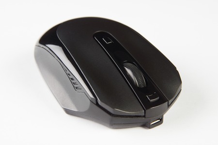 Black optical computer mouse. Wireless computer mouse isolated on white background, close-up