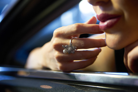 Portrait of Glamour brunette  babe sitting in yellow supercar. Young woman with black hair and red lipstick posing in sport carの写真素材
