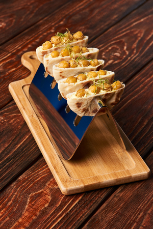 Labne and karri snack food with fried yellow peas, curry, lemon peel, in bread cake pita. Delicious...