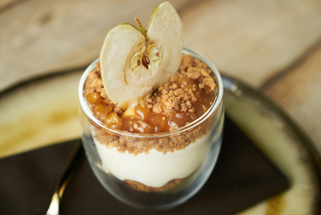 Dessert New york cheese cake with mousse with apple cream, caramel, muskovado, close-up. Healthy breakfast foodの写真素材