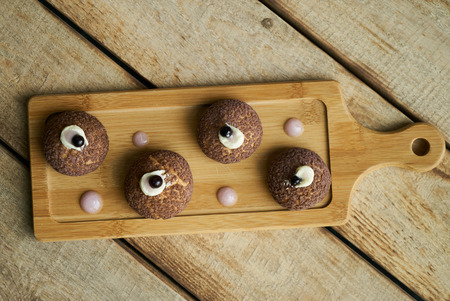 Cake Brioche shu cream chantilly, eclair. Sweet breakfast dessert. White chocolate profiteroles with peach violet.の写真素材