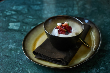 Estonian sweet dessert Kama with yoghurt mousse, wild berries and meringues. Ice cream with strawberries, currants and mint leafの写真素材