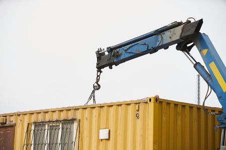 Crane truck unloading portable workers house container booth, outdoorsの写真素材