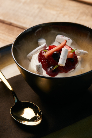 Estonian sweet dessert Kama with yoghurt mousse, wild berries and meringues. Ice cream with fresh strawberries, marshmallow, currants and mint leaf .の写真素材