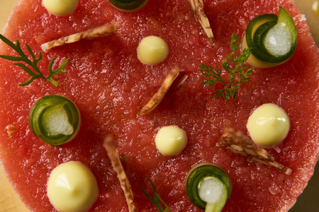 Beef tartare Steak with egg yolk, pistachios, truffle oil, green mayonnaise. Classic tartare meat with ingredients on plate. Luxury restaurant food, close-upの写真素材