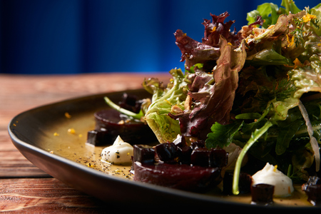 Restaurant food salad with roasted beetroot beet, Goat Cheese, Candied Walnuts, Spring Greens, and...