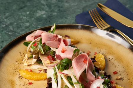 Luxury vegetable salad with Smoked duck breast.  Healthy fresh vegetable salad with smoked chiken meat, Candied Walnuts, Spring Greens, Orange and Herbsの写真素材