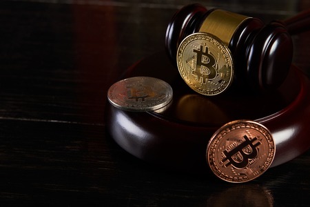 Crypto currency law, judge gavel, stacked legal book and bitcoin coin, close-up, copy space.の写真素材