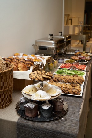 Catering wedding buffet food table on gray wall background with copy space, close-up
