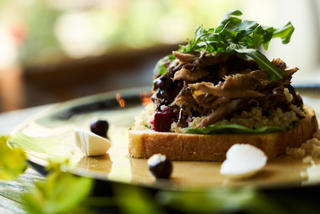 Breakfast toast bread with duck meat and quinoa, close-up.