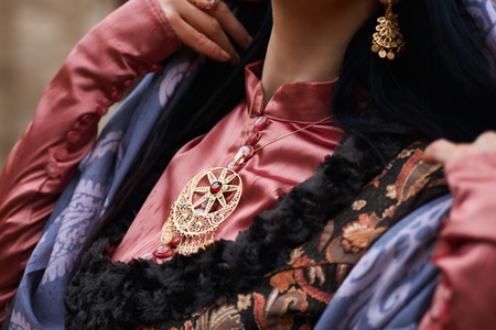 Beautiful middle eastern woman wearing traditional dress, posing outdoors, close-upの写真素材