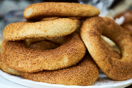 Fresh baked sesame bagle bun with sesame seed, close-up.