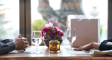 Young couple having romantic dinner in the restaurant, close-up. Beautiful loving couple is spending...