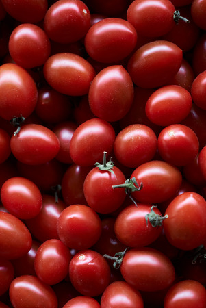 Red cherry tomato food background, close-up. Ripe Fresh Cherry Tomatoes, top view.の写真素材