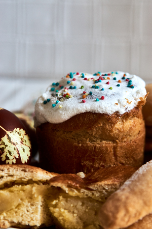 Traditional Russian Easter cakes kulich, with colored eggs, close-up.