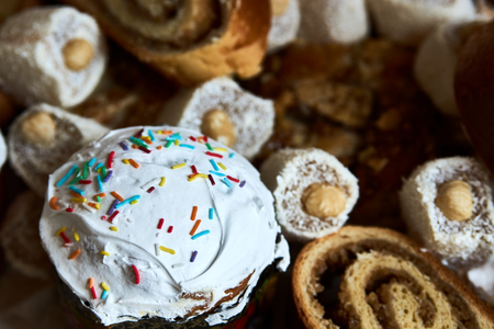 Traditional Russian Easter cakes kulich, with colored eggs, close-up.