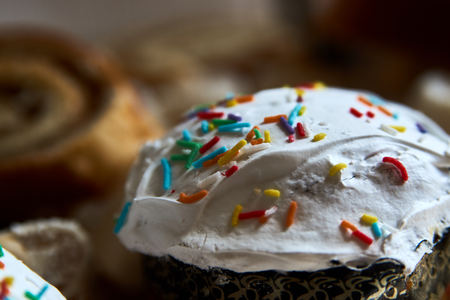 Traditional Russian Easter cakes kulich, with colored eggs, close-up.
