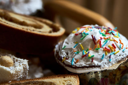 Traditional Russian Easter cakes kulich, with colored eggs, close-up.