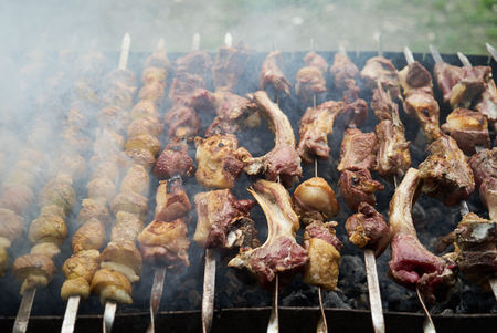 Grilled shish kebab with vegetables. BBQ grill with lamb meat and potatoes. Preparation of shish...