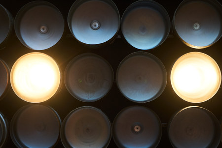 Pub and bar interior equipment, lamps made from beer barrels glow on the ceiling. Abstract backgroundの写真素材