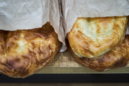 Pita flatbread. Traditional asian bread. Pita bread in paper pack in market, close-upの写真素材