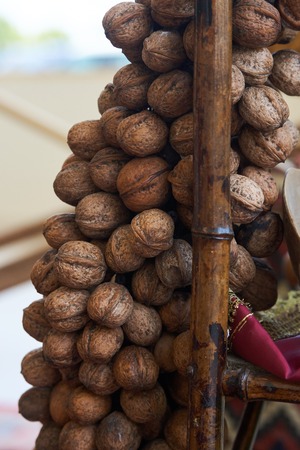 Bunch of walnuts , close-up. tasty and healthy walnuts on wood stickの写真素材