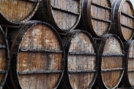 Old Wine barrels in vineyard, close-up. Winery, winemaking theme