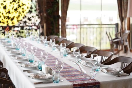 Beautifully served table in a restaurant. Table set for dining with cutlery, glassware and wine...