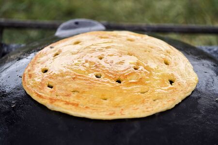 Cooking traditional Turkish borek, pide, pita or yufka bread. Traditional Turkish food. Woman...