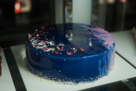 Blue cream cake in pastry shop glass display, close-upの写真素材