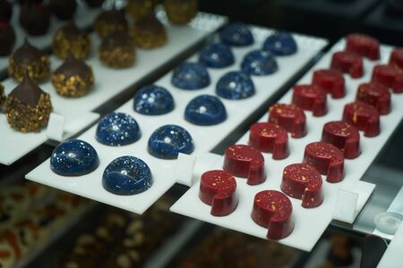 Dessert display case with sweets candies. Pastry shop. Variety of candy, close-upの写真素材