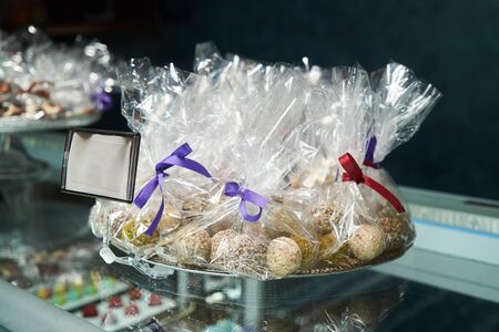 Dessert display case with sweets candies. Pastry shop. Variety of candy, close-up