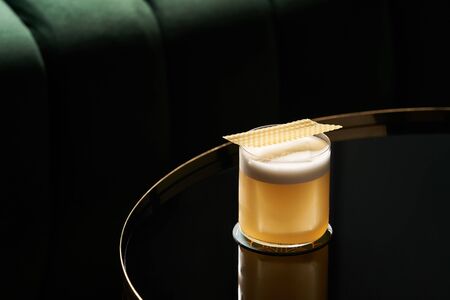 Classic cocktail glass on glass table in night club restaurant.の写真素材