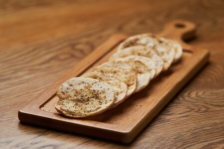 Matzah - Jewish traditional Passover bread on wooden table. Pita bread on wooden board, close-up.