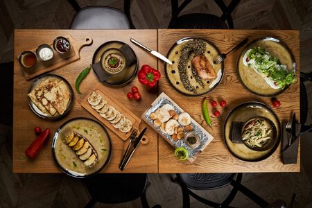 Food table with Different appetizer and antipasto. Assorted food set on wooden table. Luxury restaurant food. Served dinner tableの写真素材