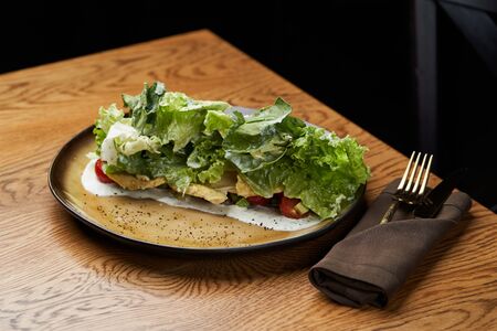 Avocado chicken salad on table, close-up. Dietary chicken salad with avocado, cucumber, arugula, cherry tomatoes and cabbage. Healthy diet foodの写真素材