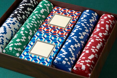Poker set case on green texture background. Poker cards and chips, close-up