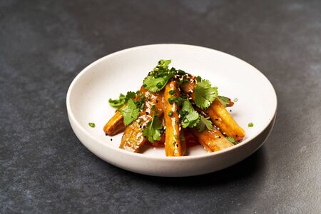 Crispy eggplant with tomatoes and sweet chili sauce. Sweet crispy eggplant or aubergine in white...