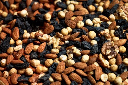 Nuts background with almonds hazelnuts walnuts raisins, close-upの写真素材