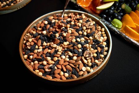 Nuts background with almonds hazelnuts walnuts raisins, close-upの写真素材